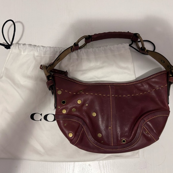 Coach leather shoulder bag with grommets.